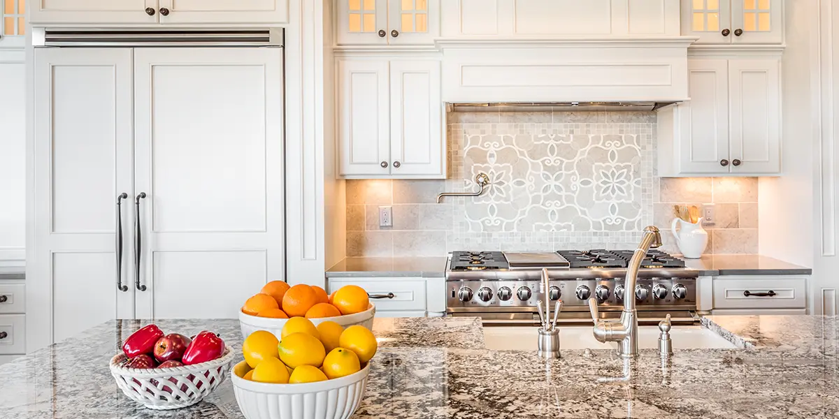 Kitchen cabinets with white finish and granite countertop