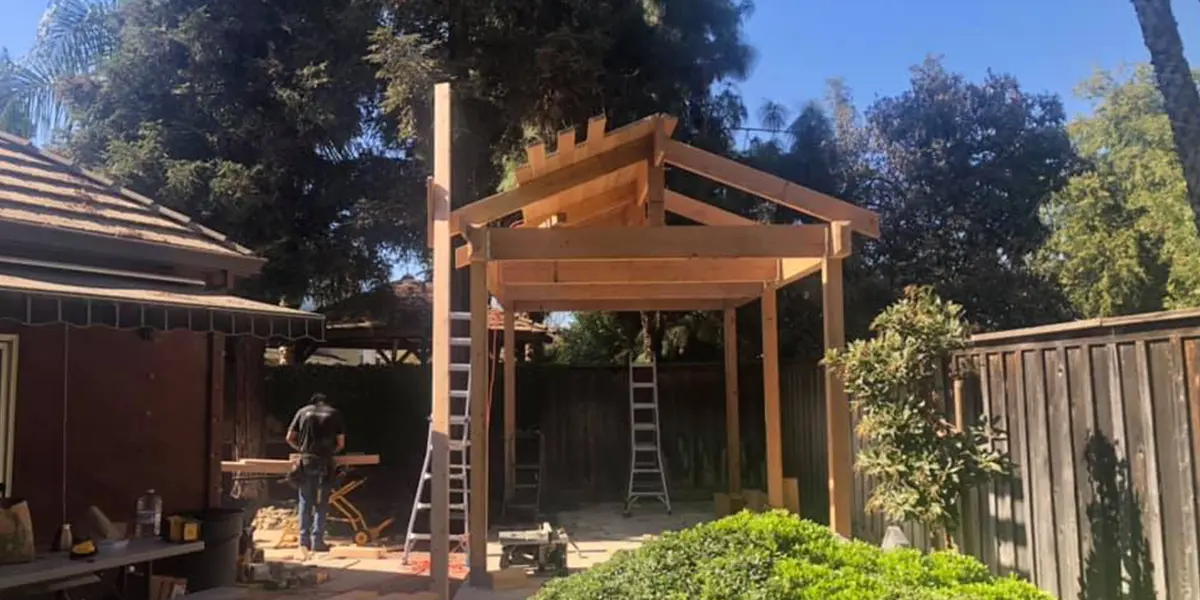 KHB team member working on a pergola outside in California