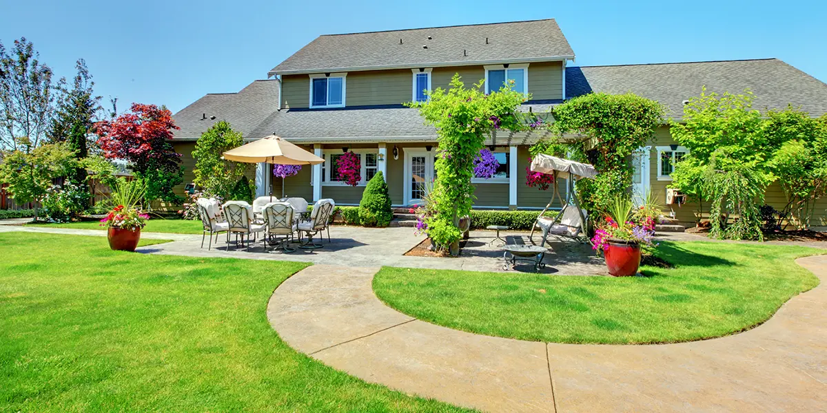 Outside view of home in California with green landscape and renovated exterior prepared for selling