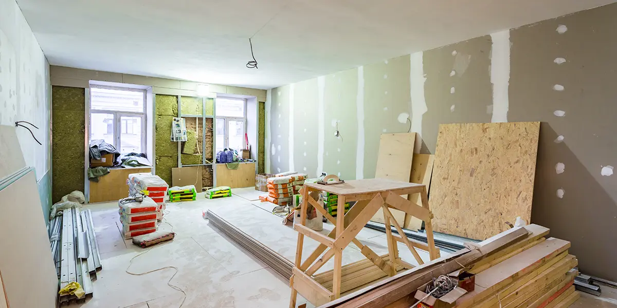 Interior of a room being renovated, bare walls, materials, and working tools