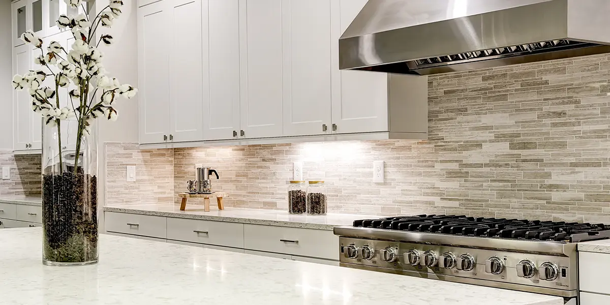Elegant kitchen with natural stone backsplash in gray colors