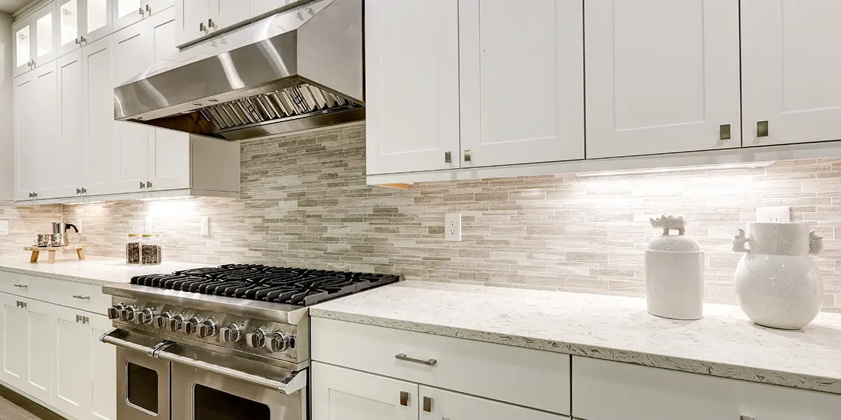 Luxurious stainless steel range hood in white kitchen