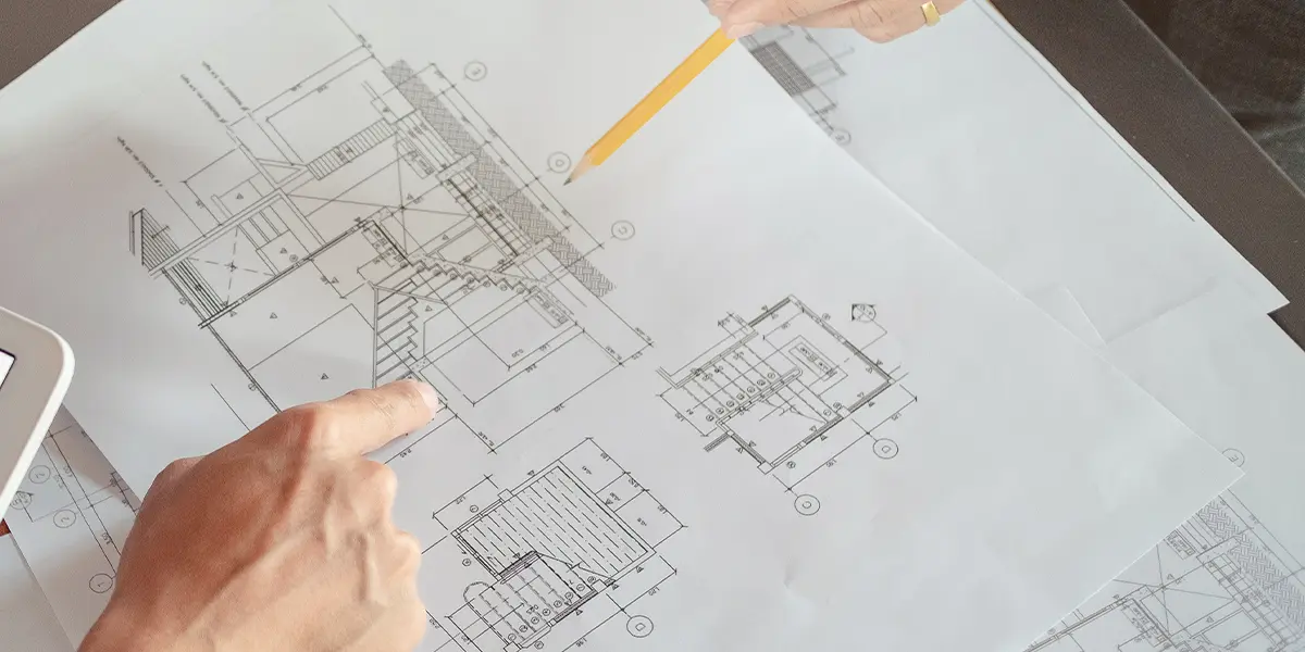 Man explaining detailed drawing of a home plan