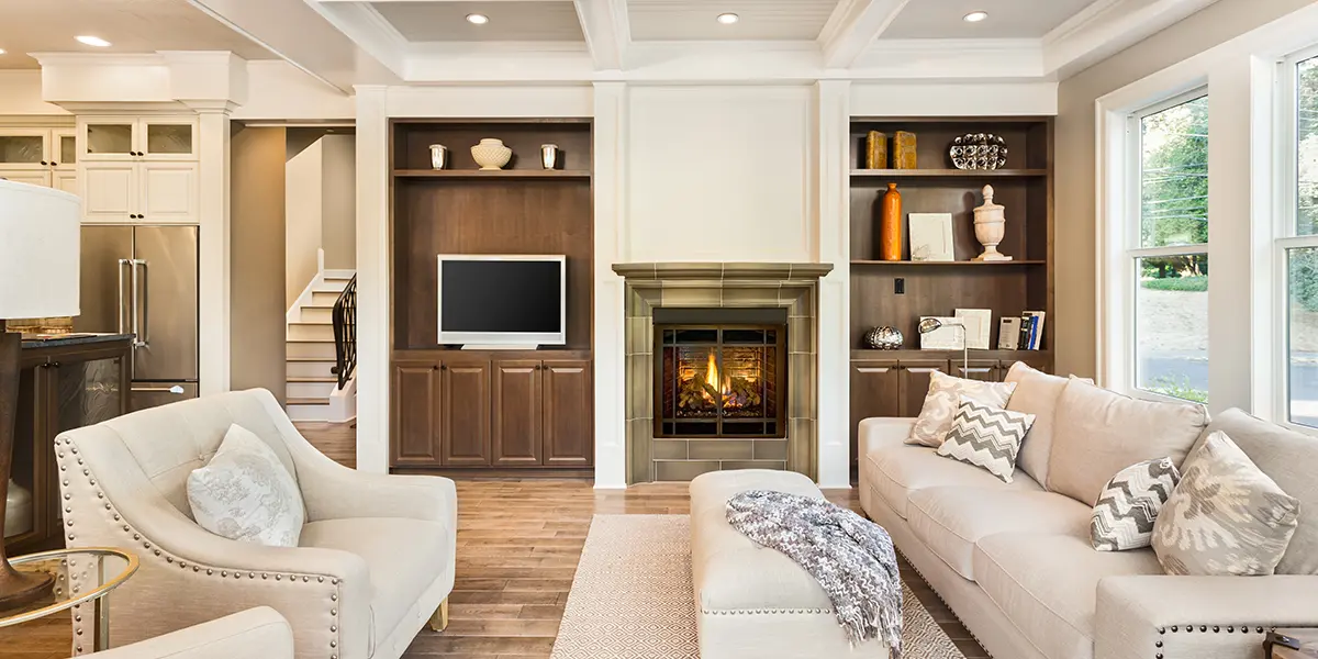 New renovated home interior with fireplace and elegant white couches
