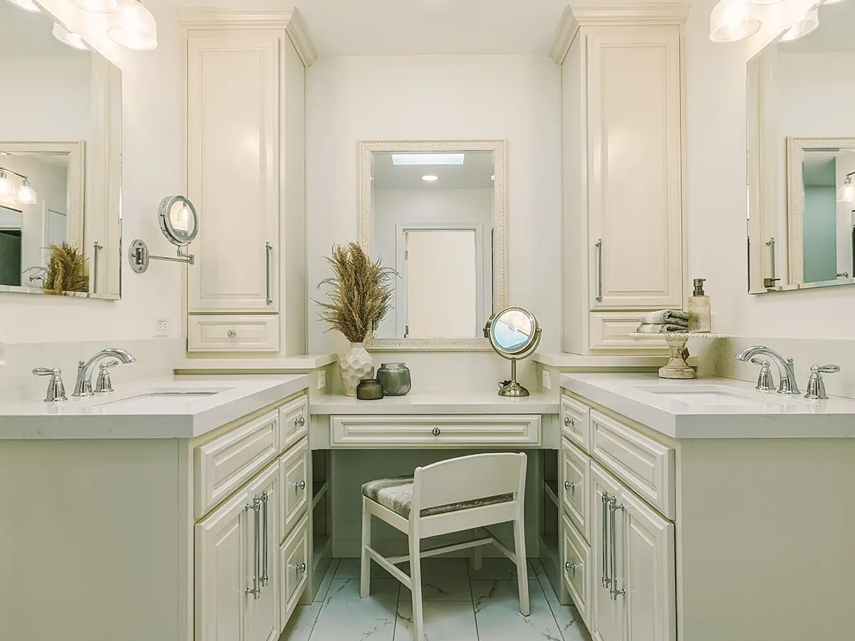 A beautiful bathroom with two simple vanities back to back