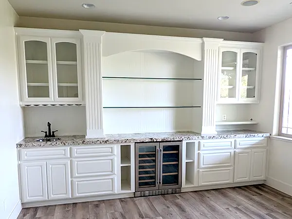 A kitchen with unfinished white cabinets