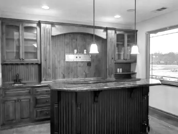 a black and white kitchen with a bar