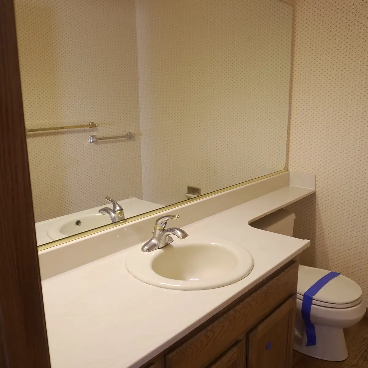 A small guest bath with wood cabinets
