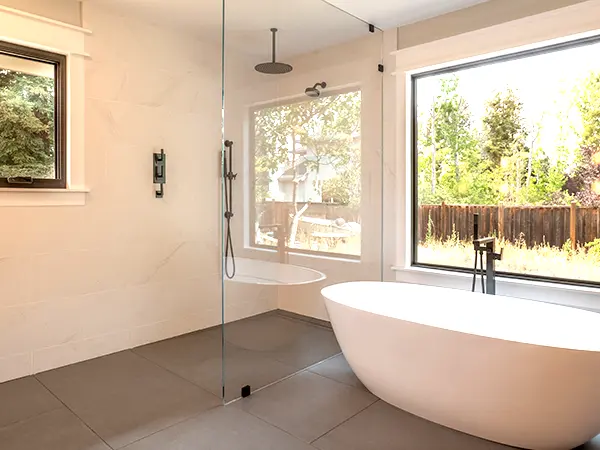 A freestanding tub and a glass shower
