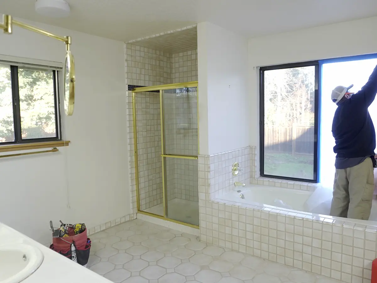 A man working on renovating a bathroom