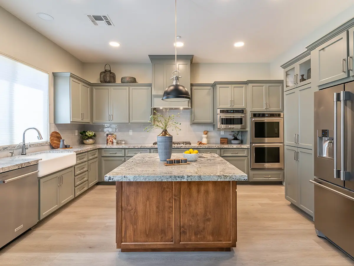 Light gray cabinets and a wooden kitchen island with quartz countertop