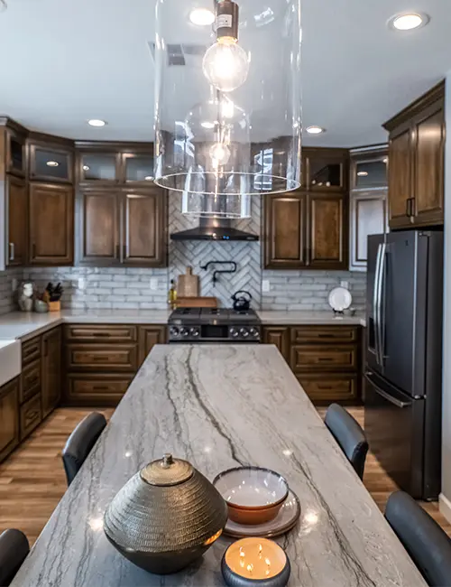 A kitchen remodel with wood cabinets and quartz countertop