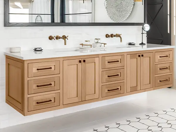 A double vanity made of wood with dark hardware