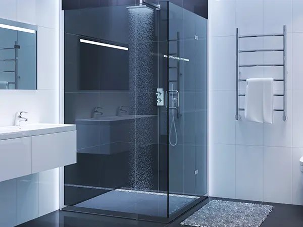 A glass walk-in shower in a bathroom with a lot of blue