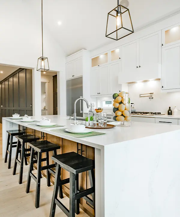 A quartz countertop with black wood chairs