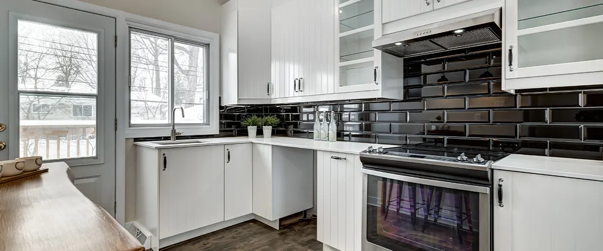 white kitchen with black backsplash
