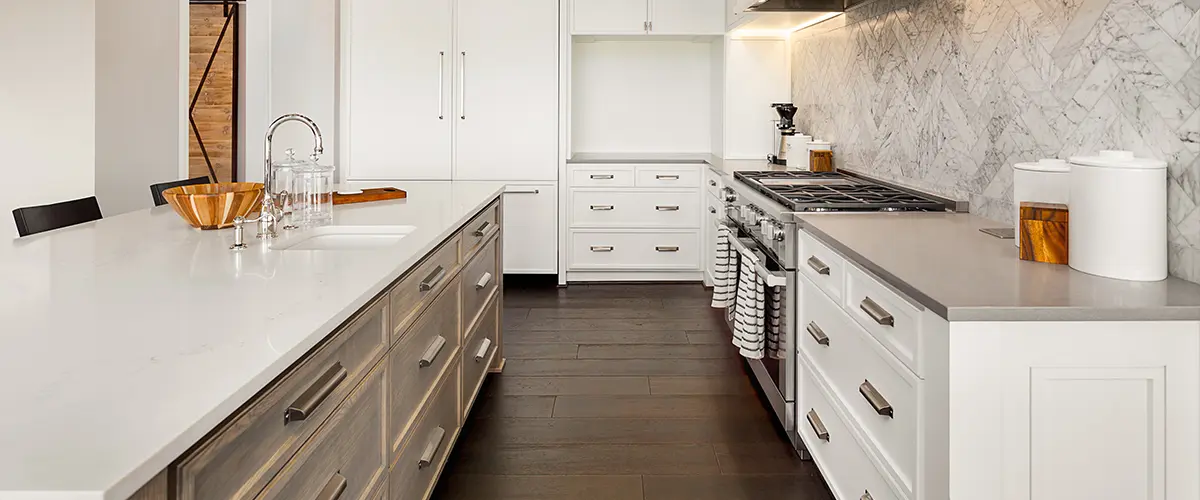 A beautiful kitchen with wood flooring and white cabinets