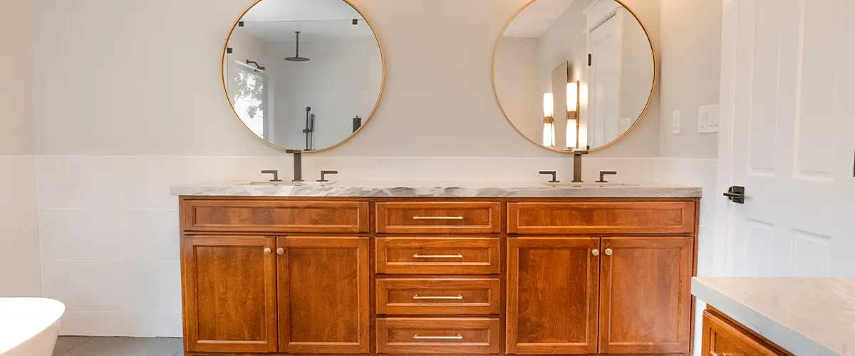 bathroom with double vanity and mirrors