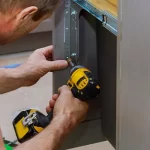 Cabinet installer refacing a cabinet door