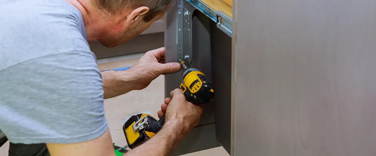 Cabinet installer refacing a cabinet door