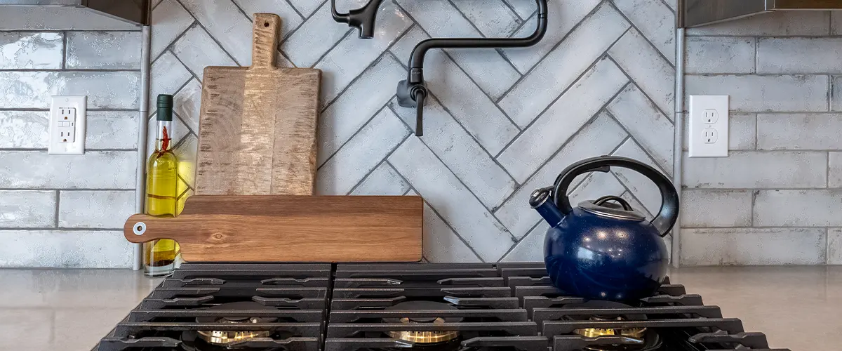 tile backsplash behind black stove