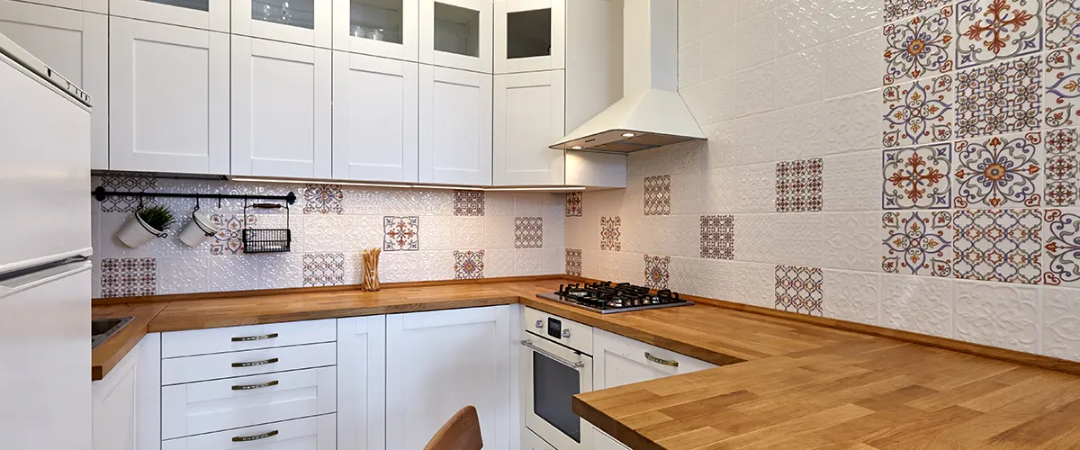 wood counterspace in kitchen with tile backsplash