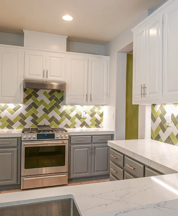 Colourful kitchen with green tiles by khb construction