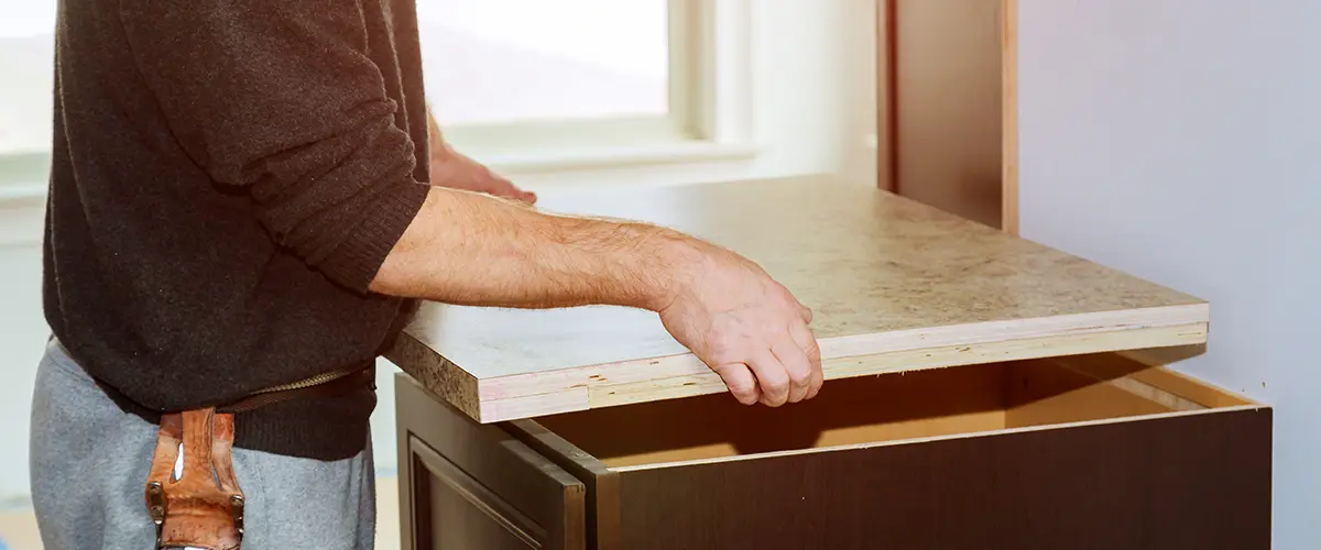 Man installing new kitchen laminate countertop materials