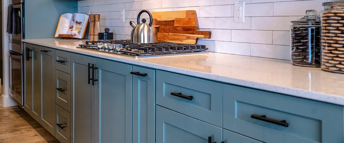 Blue kitchen cabinets with dark hardware