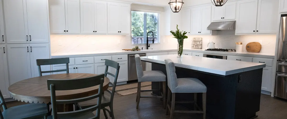 kitchen with island bar and white cabinets