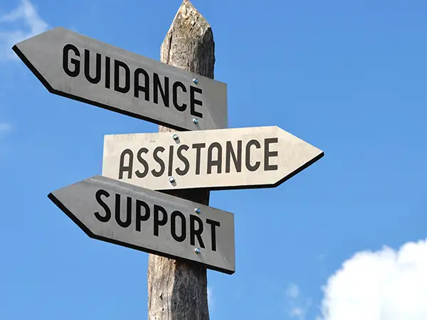 A sign that reads "guidance, assistance, support"