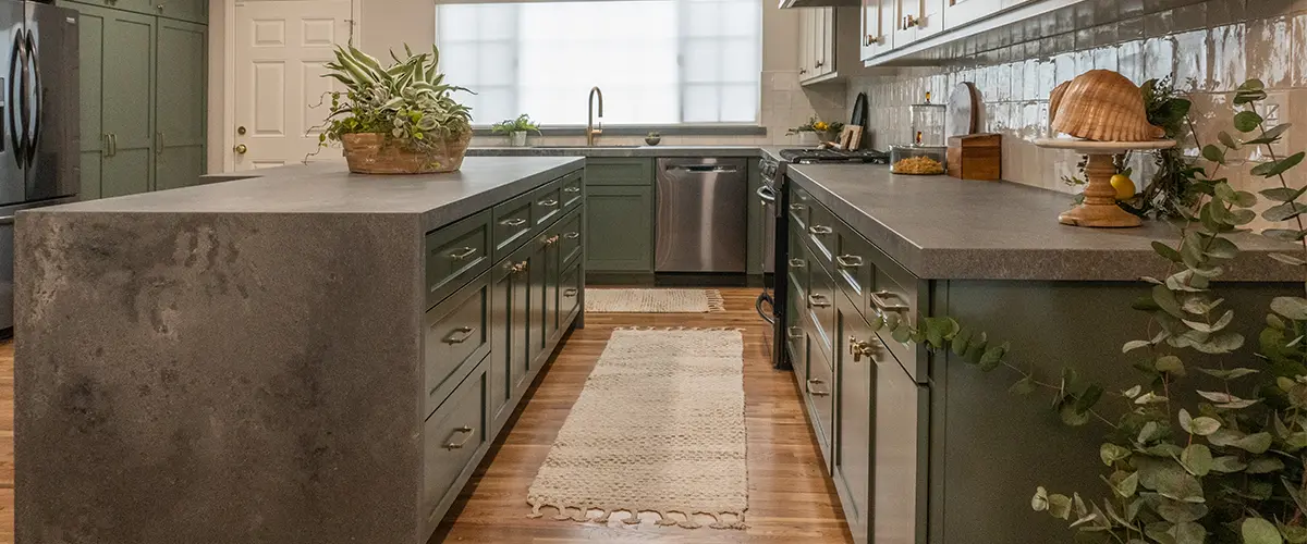 beautiful remodeled kitchen with sage cabinets and golden hardware