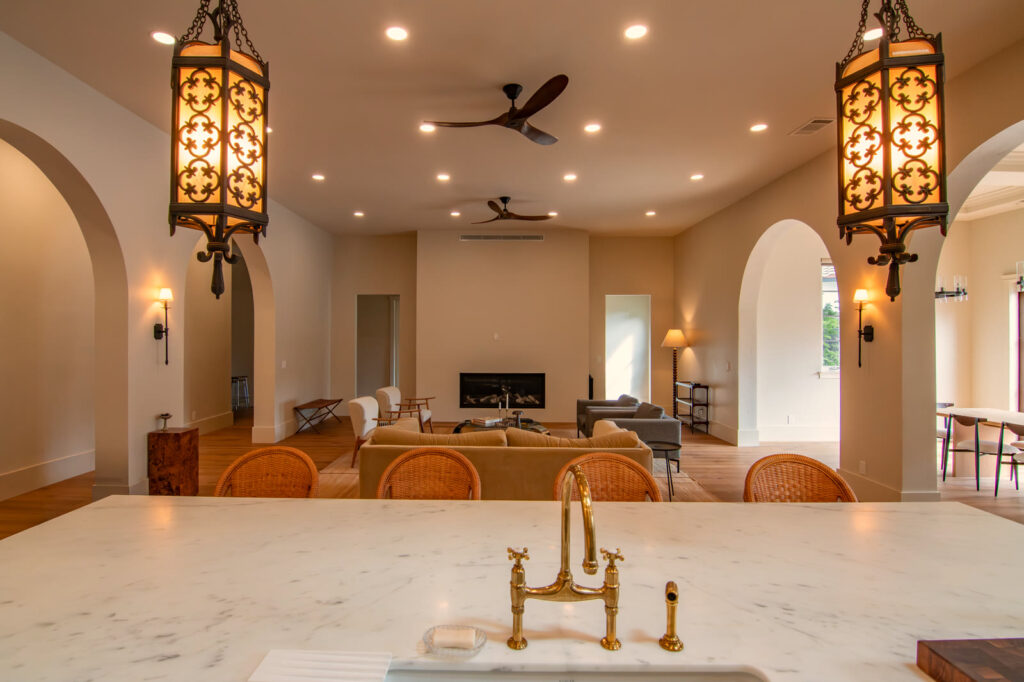The remodeled living room under matching iron lanterns