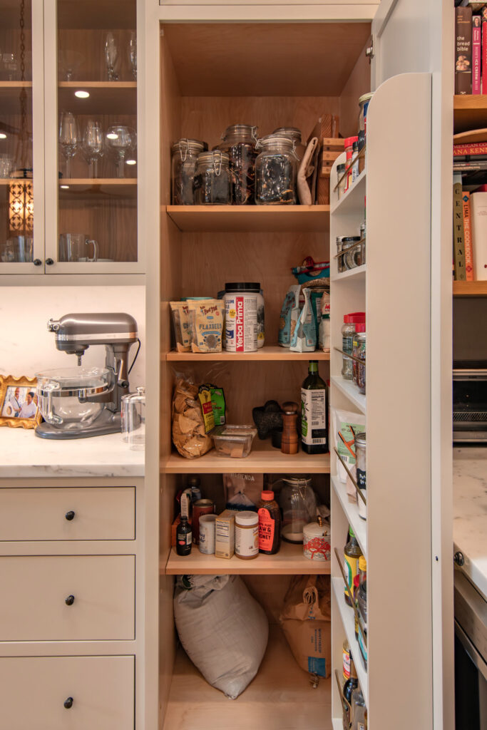 Walk-in pantry shelving stocked around a stand mixer