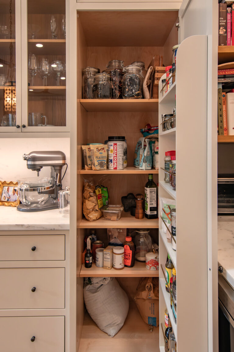 Walk-in pantry shelving stocked around a stand mixer